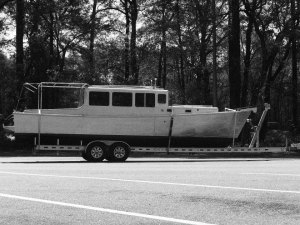 Black and white photo of boat on a trailer